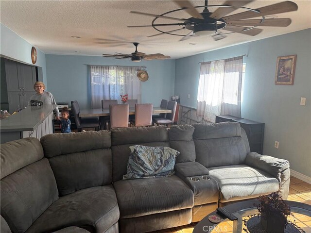 10146 Alpaca St, South El Monte, CA 91733 - living area featuring ceiling fan, plenty of natural light, a textured ceiling, and tile patterned flooring
