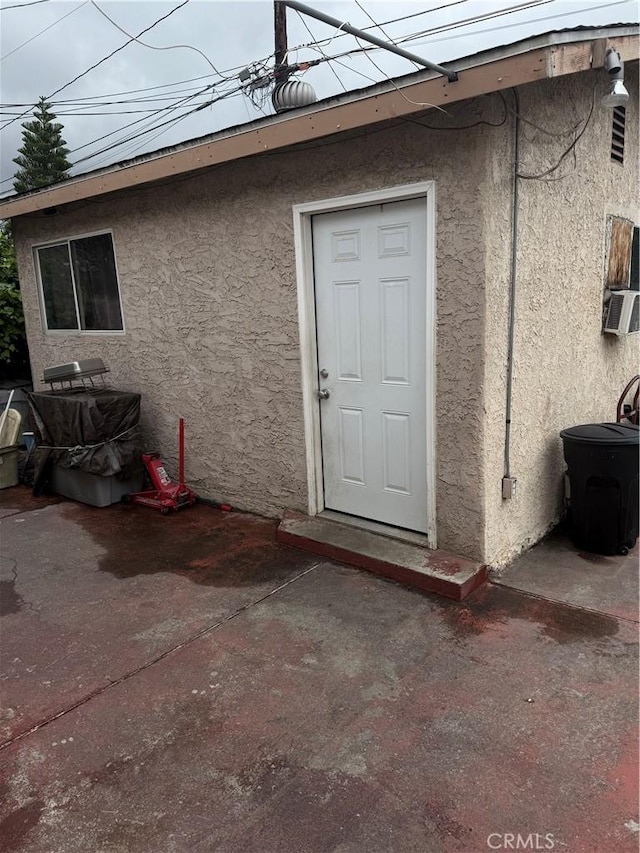 10146 Alpaca St, South El Monte, CA 91733 - doorway to property featuring stucco siding, cooling unit, and a patio
