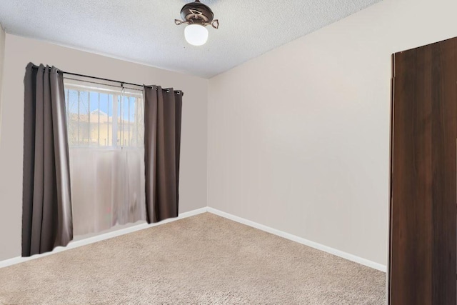 1703 W 25th St, Los Angeles, CA 90018 - empty room with carpet floors, a textured ceiling, and baseboards