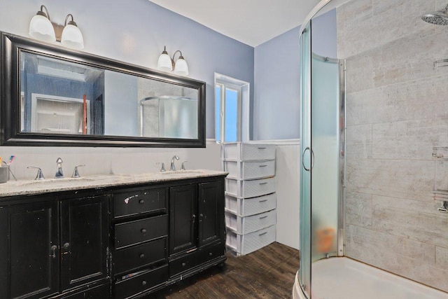 1703 W 25th St, Los Angeles, CA 90018 - bathroom with a stall shower, wood finished floors, and double vanity