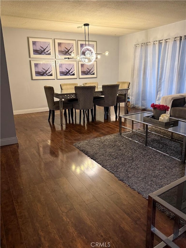 9617 Greenwood Ave, Montclair, CA 91763 - dining area with wood-type flooring, a textured ceiling, and baseboards