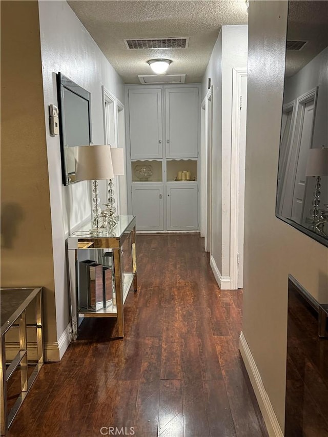 9617 Greenwood Ave, Montclair, CA 91763 - hall with dark wood finished floors, a textured ceiling, and baseboards
