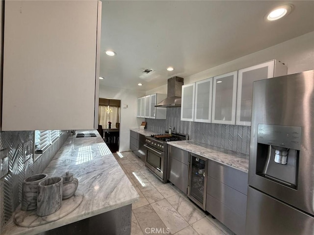 9617 Greenwood Ave, Montclair, CA 91763 - kitchen featuring stainless steel appliances, wall chimney exhaust hood, beverage cooler, tasteful backsplash, and light marble finish flooring