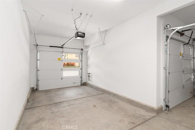 554 Catalonia, Lake Forest, CA 92630 - garage featuring a garage door opener and baseboards