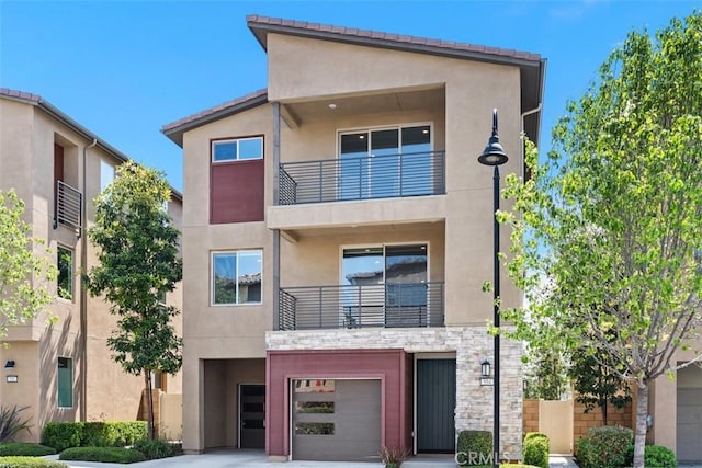 554 Catalonia, Lake Forest, CA 92630 - view of front of house featuring a balcony, stucco siding, and an attached garage