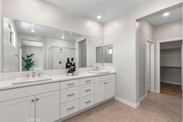 554 Catalonia, Lake Forest, CA 92630 - full bath featuring a shower stall, double vanity, a walk in closet, baseboards, and recessed lighting
