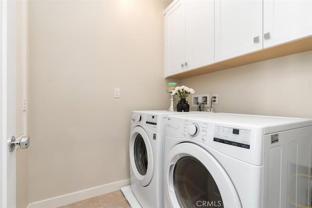 554 Catalonia, Lake Forest, CA 92630 - laundry area with cabinet space, washer and clothes dryer, baseboards, and light tile patterned flooring