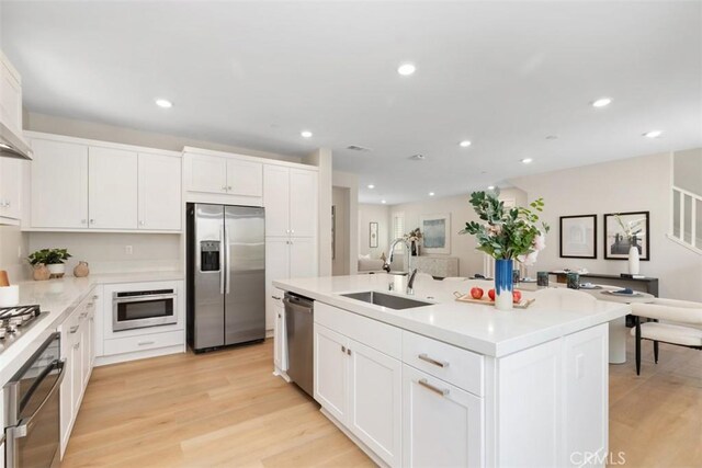 554 Catalonia, Lake Forest, CA 92630 - kitchen with stainless steel appliances, a sink, light wood-style flooring, white cabinets, and recessed lighting