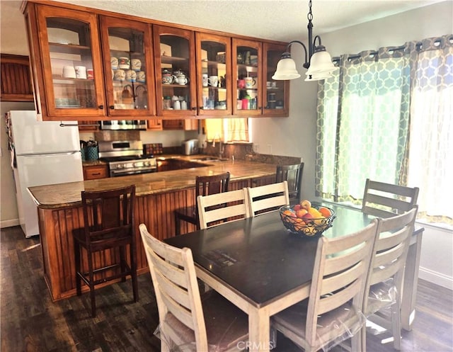 8149 Langdon Ave, Hesperia, CA 92345 - dining room featuring dark wood finished floors and a chandelier