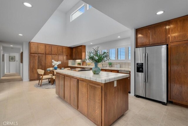 1467 18th St, Manhattan Beach, CA 90266 - kitchen featuring stainless steel fridge, tile counters, recessed lighting, a center island, and light flooring