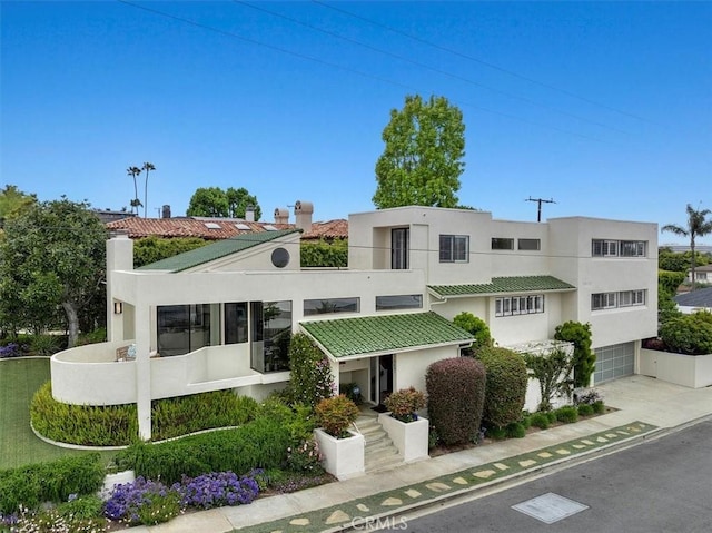 1467 18th St, Manhattan Beach, CA 90266 - view of building exterior with a garage and concrete driveway