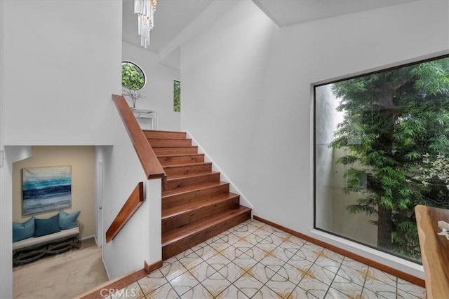 1467 18th St, Manhattan Beach, CA 90266 - stairs featuring baseboards, a chandelier, and a towering ceiling