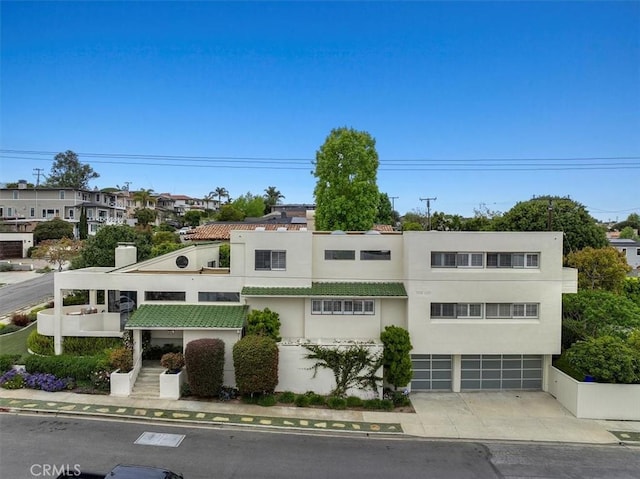 1467 18th St, Manhattan Beach, CA 90266 - view of front of house featuring an attached garage, stucco siding, and driveway