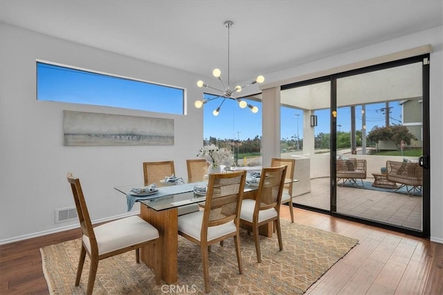 1467 18th St, Manhattan Beach, CA 90266 - dining area with a chandelier, wood finished floors, and baseboards