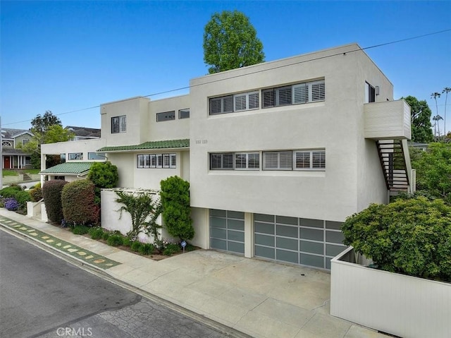 1467 18th St, Manhattan Beach, CA 90266 - art deco house with stairway, stucco siding, a garage, and driveway