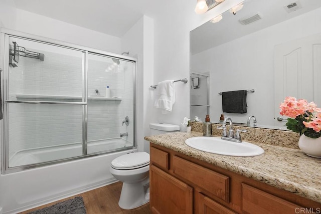 15048 Avenida Venusto Unit 255, San Diego, CA 92128 - full bathroom featuring wood finished floors, toilet, vanity, and enclosed tub / shower combo