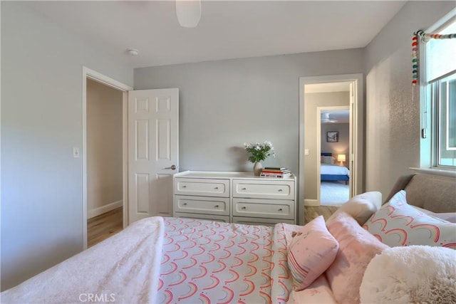 45792 Sutton Dr, Oakhurst, CA 93644 - bedroom with multiple windows, wood finished floors, and baseboards