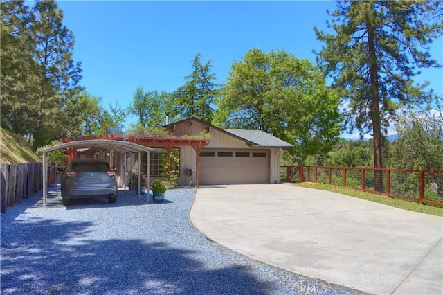 45792 Sutton Dr, Oakhurst, CA 93644 - view of front facade featuring driveway, fence, a carport, and an attached garage