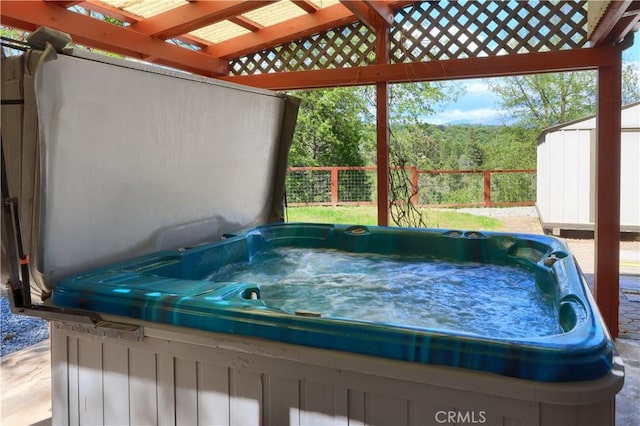 45792 Sutton Dr, Oakhurst, CA 93644 - wooden deck featuring a hot tub, a storage shed, and an outdoor structure