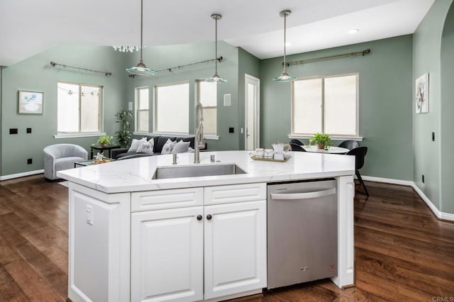 kitchen featuring dishwasher, a sink, open floor plan, a kitchen island with sink, and white cabinets