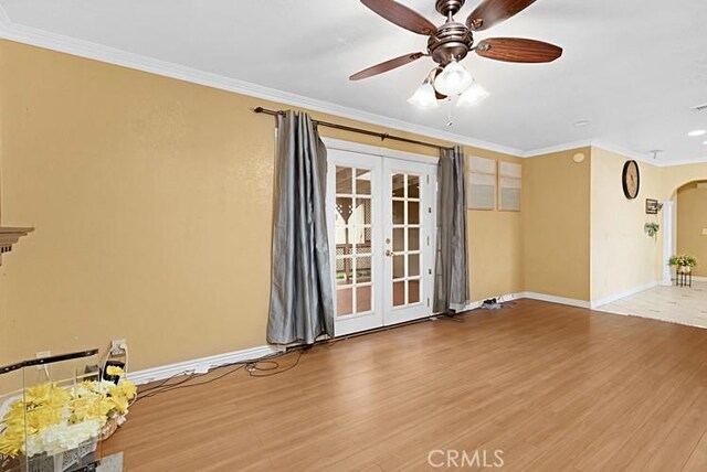 4340 Highland Ave, Oxnard, CA 93033 - empty room featuring french doors, arched walkways, crown molding, wood finished floors, and baseboards