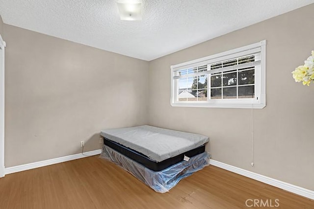 4340 Highland Ave, Oxnard, CA 93033 - bedroom with wood finished floors, baseboards, and a textured ceiling