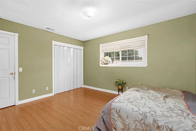 4340 Highland Ave, Oxnard, CA 93033 - bedroom with baseboards, wood finished floors, a closet, and a textured ceiling