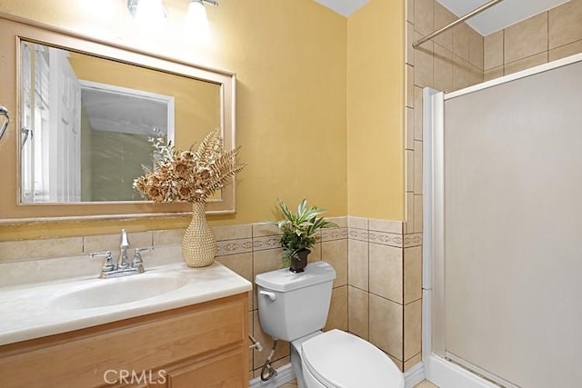 4340 Highland Ave, Oxnard, CA 93033 - full bathroom featuring a shower stall, toilet, vanity, tile walls, and wainscoting