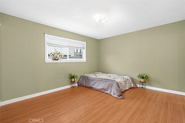 4340 Highland Ave, Oxnard, CA 93033 - bedroom with wood finished floors, baseboards, and a textured ceiling