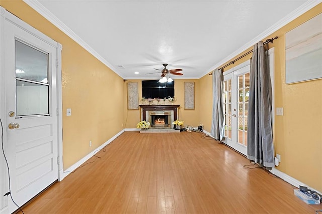 4340 Highland Ave, Oxnard, CA 93033 - unfurnished living room featuring a ceiling fan, crown molding, baseboards, light wood-style flooring, and a lit fireplace