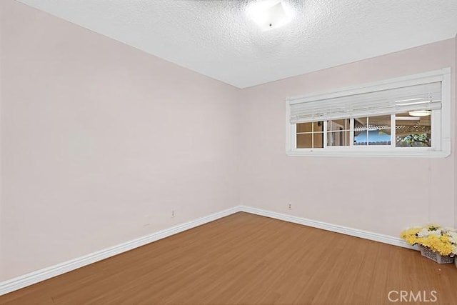 4340 Highland Ave, Oxnard, CA 93033 - spare room featuring wood finished floors, baseboards, and a textured ceiling