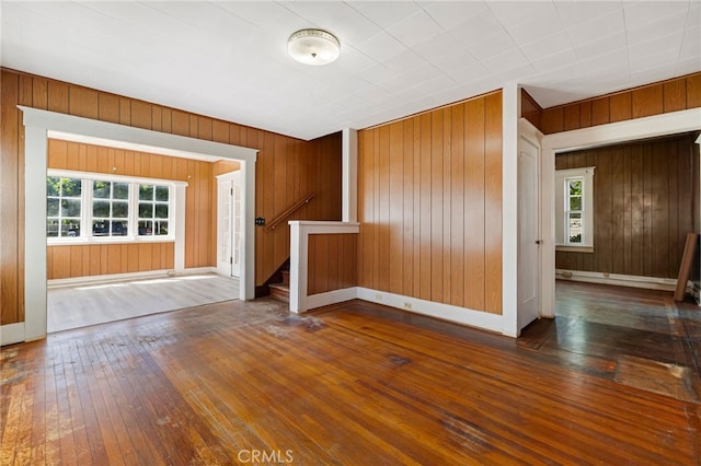 440 S Plumas St, Willows, CA 95988 - unfurnished living room with stairs, hardwood / wood-style flooring, wood walls, and baseboards