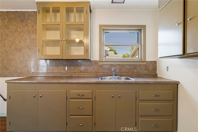440 S Plumas St, Willows, CA 95988 - kitchen featuring a sink, backsplash, glass insert cabinets, ornamental molding, and dark countertops