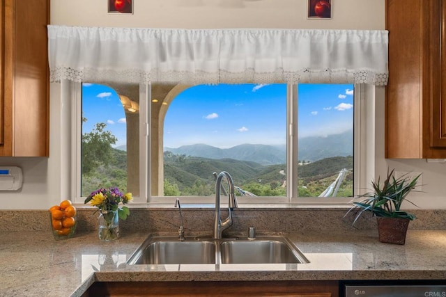 2389 Eric Rd, Fallbrook, CA 92028 - kitchen featuring a sink, brown cabinets, dishwasher, a mountain view, and light stone countertops