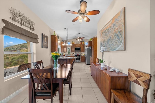 2389 Eric Rd, Fallbrook, CA 92028 - dining area with ceiling fan, light tile patterned floors, vaulted ceiling, and baseboards