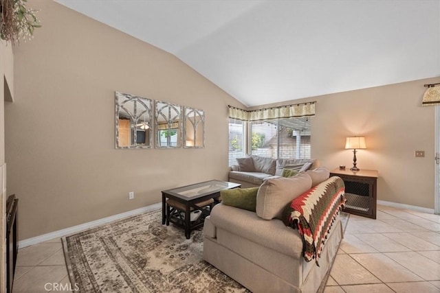 living room featuring lofted ceiling, light tile patterned floors, and baseboards