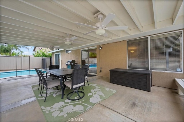 view of patio featuring ceiling fan, fence, a grill, and outdoor dining space