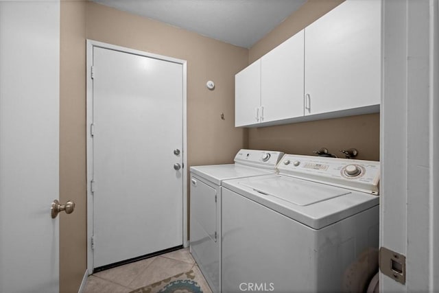 laundry room with cabinet space, separate washer and dryer, and light tile patterned floors