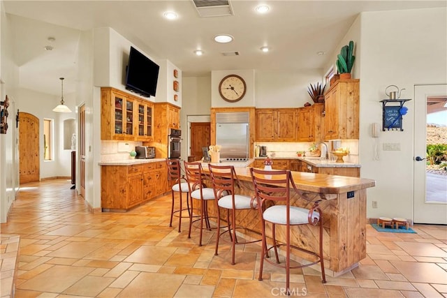 31024 Rabbit Springs Rd, Lucerne Valley, CA 92356 - kitchen featuring stainless steel appliances, backsplash, light countertops, brown cabinets, and recessed lighting