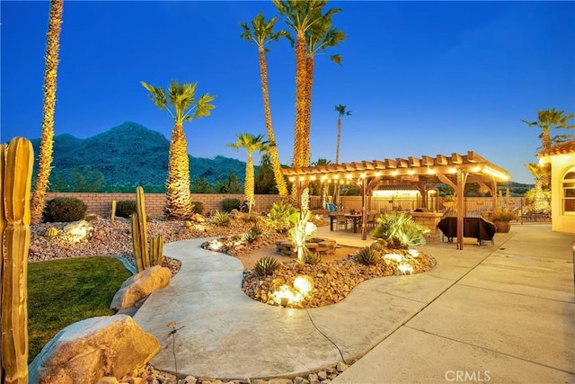 31024 Rabbit Springs Rd, Lucerne Valley, CA 92356 - view of patio / terrace featuring an outdoor fire pit, a fenced backyard, a mountain view, and a pergola