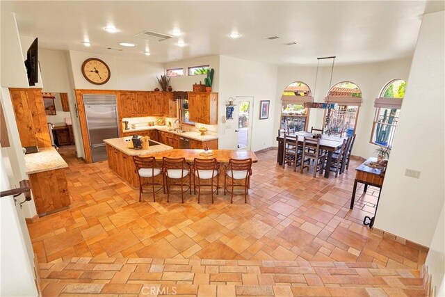 31024 Rabbit Springs Rd, Lucerne Valley, CA 92356 - kitchen with appliances with stainless steel finishes, light countertops, brown cabinets, a sink, and healthy amount of natural light