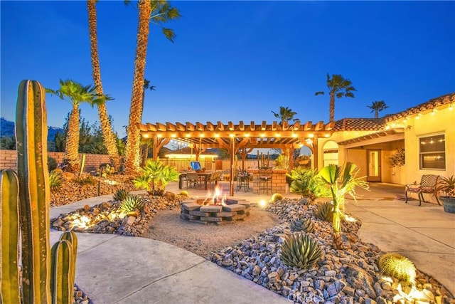 31024 Rabbit Springs Rd, Lucerne Valley, CA 92356 - view of patio with an outdoor fire pit, fence, and a pergola
