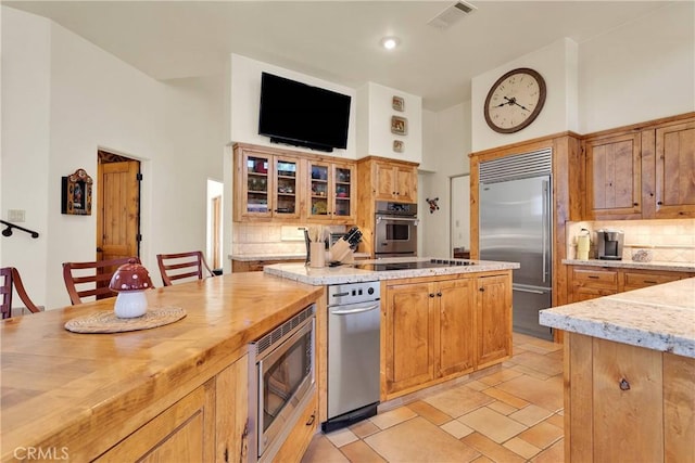 31024 Rabbit Springs Rd, Lucerne Valley, CA 92356 - kitchen featuring built in appliances, decorative backsplash, butcher block countertops, glass insert cabinets, and recessed lighting