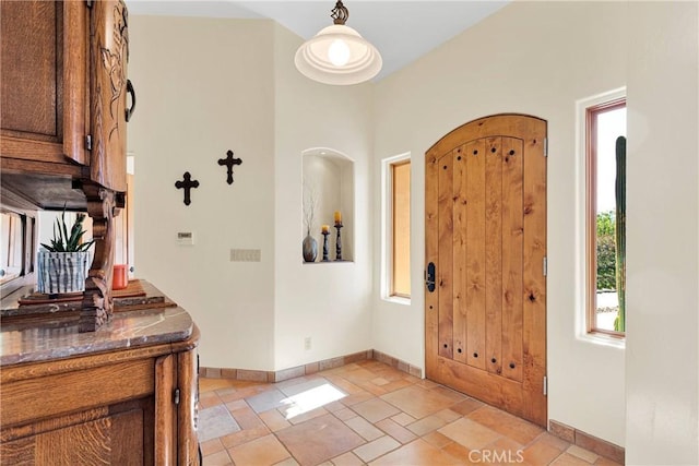 31024 Rabbit Springs Rd, Lucerne Valley, CA 92356 - entrance foyer with baseboards, stone tile flooring, and arched walkways