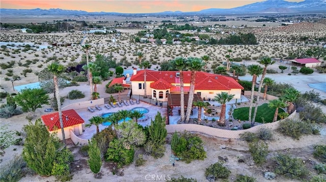 31024 Rabbit Springs Rd, Lucerne Valley, CA 92356 - aerial view at dusk of a mountain view, view of pool area, and a desert view