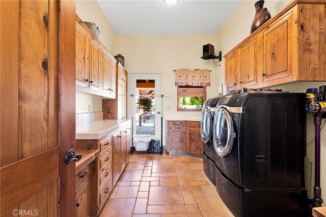 31024 Rabbit Springs Rd, Lucerne Valley, CA 92356 - washroom featuring cabinet space, washer and dryer, and stone tile floors