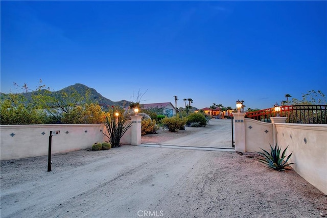 31024 Rabbit Springs Rd, Lucerne Valley, CA 92356 - view of dirt / gravel driveway with a gated entry and a gate