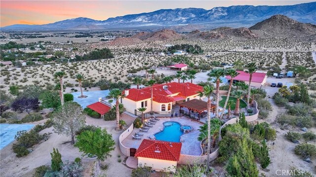 31024 Rabbit Springs Rd, Lucerne Valley, CA 92356 - aerial view of property and surrounding area featuring mountains, a pool, and a desert landscape