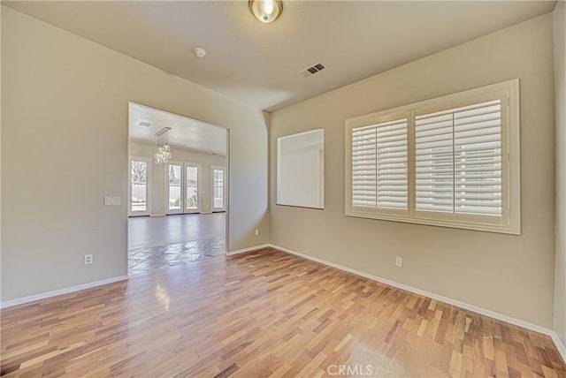 43922 Carentan Dr, Temecula, CA 92592 - spare room featuring wood finished floors and a chandelier