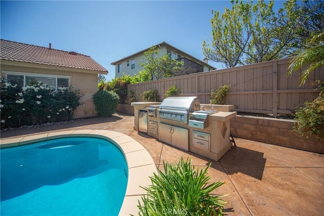 43922 Carentan Dr, Temecula, CA 92592 - view of swimming pool featuring exterior kitchen, a fenced backyard, and a patio area